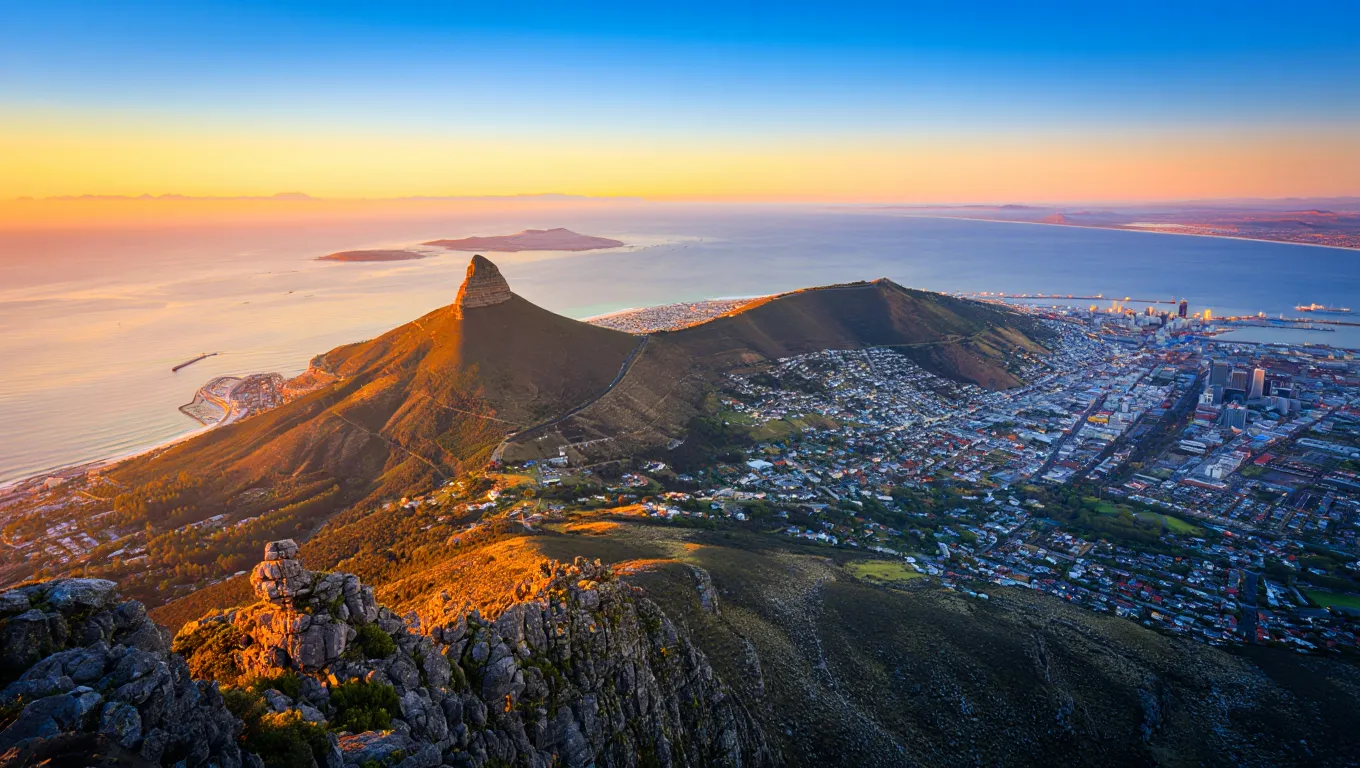 Cape Town cityscape with Lion’s Head mountain and ocean at golden hour