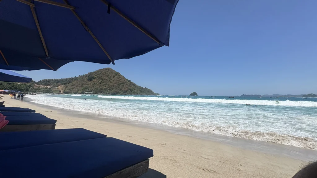 An empty, pristine white-sand beach with turquoise water in southern Lombok.