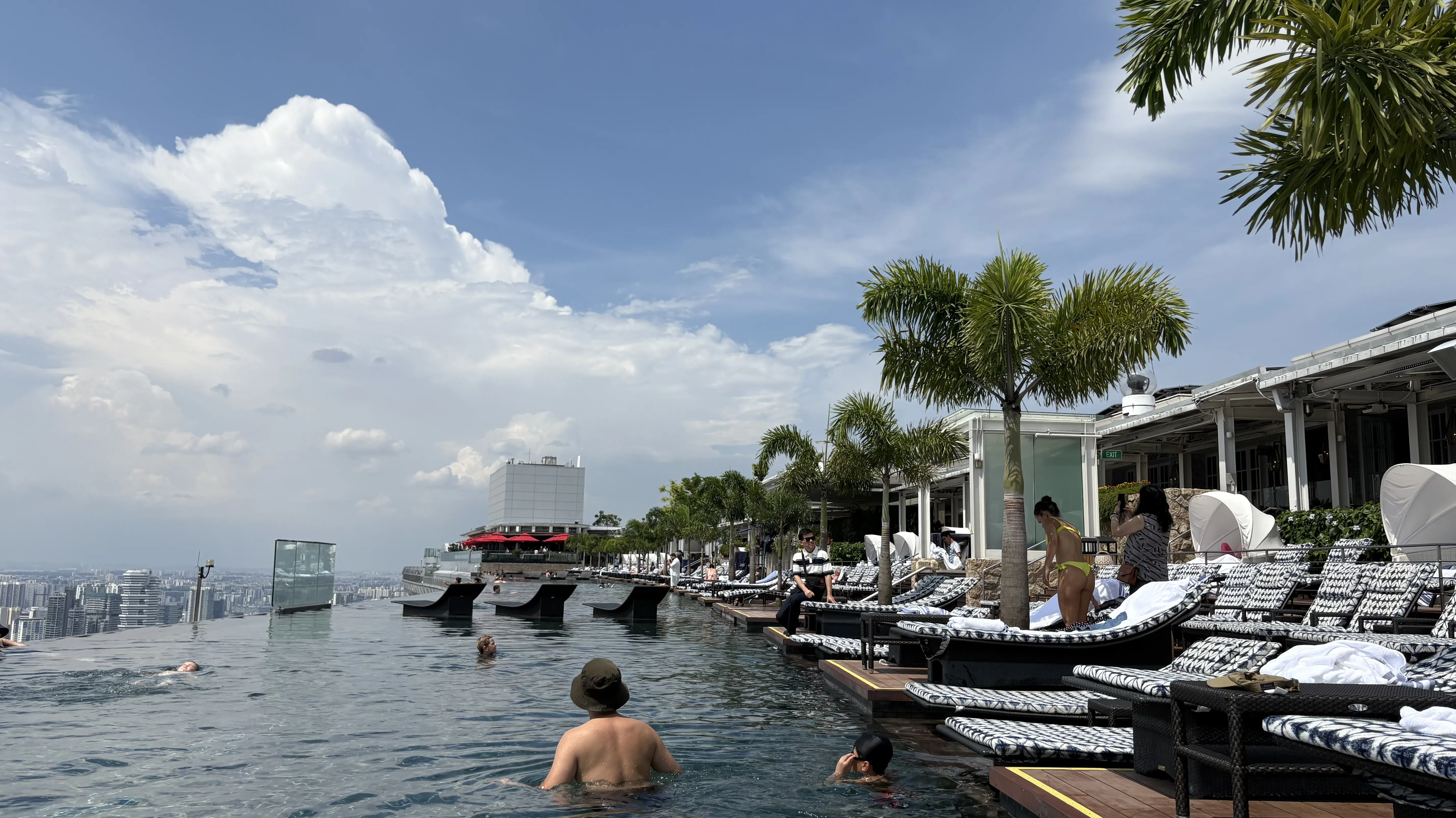 The iconic Marina Bay Sands infinity pool at dusk, with the glittering Singapore skyline in the background.