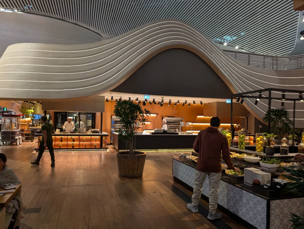 Istanbul Business Lounge wide view with food stations and seating zones