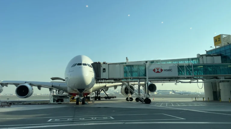 A massive Emirates Airbus A380 parked at a gate, illustrating the scale of global aviation networks often accessed through Airline Alliances and partnerships.